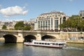 Paris, France - September 1, 2019: Tourist ship on the Seine river and La Samaritaine department store at the background