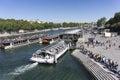 PARIS, FRANCE - SEPTEMBER 15, 2019: Tourists are waiting in a long line on the bank of Seine river to board on a cruise boat Royalty Free Stock Photo