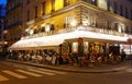 The traditional French brasserie Le Vaudeville at night. It is located near Brogniart palace in Paris, France.