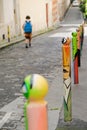 Paris, France - series of decorated bollards in Montmartre. Hip artwork on roadside poles. Day cityscape of Parisian street.