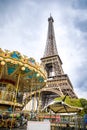 Paris, France - 24.04.2019: View from the bottom of The Eiffel Tower and Carousel in Paris in cloudy day, France