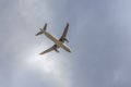 Paris, France - 07 07 2023: White and blue plane with chassis is landing on the sky with clouds background Royalty Free Stock Photo