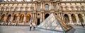 PARIS - JUNE 16: Pyramid and Louvre Museum (former Royal Palace). Louvre is one of the main touristic sites and Pyramid serves Royalty Free Stock Photo