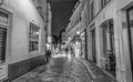 PARIS - JUNE 23, 2014: Tourists and locals walk in Montmartre streets at night. Montmartre attracted many famous modern painters