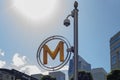 Paris la Defense, France - June 12, 2022: Yellow letter M, symbol of the Paris Metro