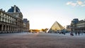 Paris Louvre Museum. Sun`s rays shine through the famous glass pyramid