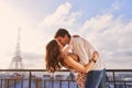 Paris, love and couple together for a kiss, romantic time or balcony of apartment, hotel with Eiffel Tower in background