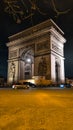 PARIS - March 10, 2023: The Arch of Triumph of the Star The Arc de Triomphe de l\'Etoile and traffic lights at night. Paris Royalty Free Stock Photo