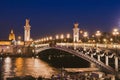 Paris by night, beautiful illumination of Alexandre III bridge on Seine river