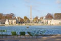 Tuileries garden fountain and Place de la Concorde obelisk view with people, sunny day in Paris Royalty Free Stock Photo