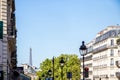 PARIS - September 3, 2019 : Haussmann building and Eiffel Tower view from a Parisian Boulevard Royalty Free Stock Photo