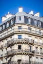 PARIS - September 3, 2019 : Traditional Haussmann building and french flag view from a Parisian Boulevard