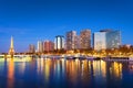 Paris skyline, Eiffel tower and buildings by night, reflection in the Seine Royalty Free Stock Photo