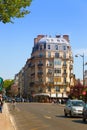 Paris Street with shops and cafe tables. Royalty Free Stock Photo