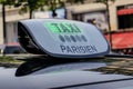 Paris taxi detail and Arc de Triomphe in the background