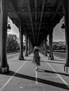 Black and White Photography of Lady in red walking under the bridge Bir Hakeim, in Paris Royalty Free Stock Photo