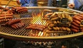 Closeup of hanging grill rust over open charcoal fire with variety french sausages on christmas market