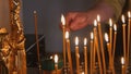 The parishioner put a candle inside an Orthodox church Royalty Free Stock Photo