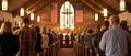 Parishioners stand respectfully in a church adorned with an American flag, engaged in a service that blends faith with