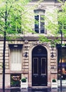 Parisian architecture and historical buildings, restaurants and boutique stores on streets of Paris, France