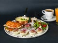 Parisian breakfast - corn porridge, croissant with sliced chicken, rucola, tomato and cheese salad with pesto sauce, boiled Royalty Free Stock Photo
