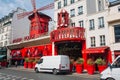 Parisian cabaret Moulin Rouge . Red tower, mill wings and inscription Moulin Rouge