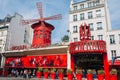 Parisian cabaret Moulin Rouge . Red tower, mill wings and inscription Moulin Rouge
