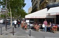 Parisian cafes with terraces and people at the Invalides Quarter close to Champ-de-Mars. Paris, France.