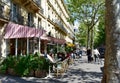 Parisian cafes with terraces and people at the Latin Quarter. Boulevard Saint Germain. Paris, France.