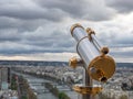 Parisian cityscape with spyglass from Eiffel Tower viewpoint. View of Seine River with bridges and Ile aux Cygnes