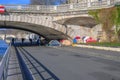 Parisian jogger working out along the Seine River and passing-by the tents of homeless people tents Royalty Free Stock Photo