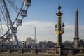 Parisian landscape of the Place of the Concorde in Paris with its famous fountain, the Ferris wheel and the Eiffel Tower in the Royalty Free Stock Photo