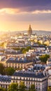 Parisian Rooftops at Golden Hour with Distant Dome Under Dramatic Sky Royalty Free Stock Photo