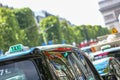 Parisian taxi on avenue des champs-elysees, with the Arc de Trio Royalty Free Stock Photo