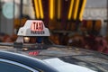 Parisian Taxi sign and car circulating with customer in the Paris streets