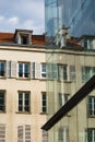 Old Parisian apartment buildings are reflected in a new glass office building Royalty Free Stock Photo