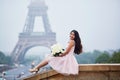 Parisian woman in front of the Eiffel tower Royalty Free Stock Photo