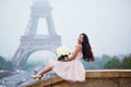 Parisian woman in front of the Eiffel tower Royalty Free Stock Photo