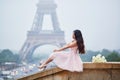 Parisian woman in front of the Eiffel tower Royalty Free Stock Photo