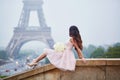 Parisian woman in front of the Eiffel tower Royalty Free Stock Photo