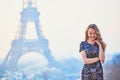 Parisian woman near the Eiffel tower at morning Royalty Free Stock Photo