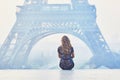 Parisian woman near the Eiffel tower at morning Royalty Free Stock Photo