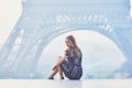 Parisian woman near the Eiffel tower at morning Royalty Free Stock Photo