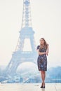 Parisian woman near the Eiffel tower at morning Royalty Free Stock Photo