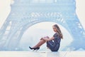 Parisian woman near the Eiffel tower at morning Royalty Free Stock Photo