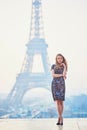 Parisian woman near the Eiffel tower at morning Royalty Free Stock Photo