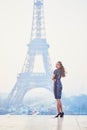 Parisian woman near the Eiffel tower at morning Royalty Free Stock Photo