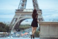 Parisian woman near the Eiffel tower in Paris, France. Royalty Free Stock Photo