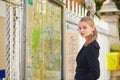 Parisian woman near the subway plan, looking for the direction Royalty Free Stock Photo