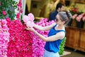 Parisian woman selecting peonies in flower shop Royalty Free Stock Photo